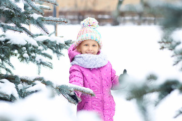 Portrait of cute little girl in winter park