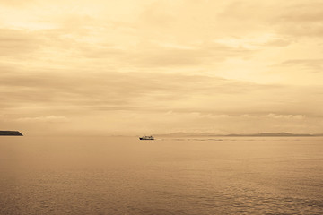 Gloomy seascape line horizon the ship is coming.