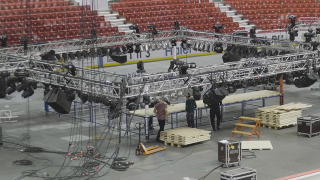 Different parts of metal scaffold on construction field. Workers build a concert stage. worker build a concert stage. stage equipment