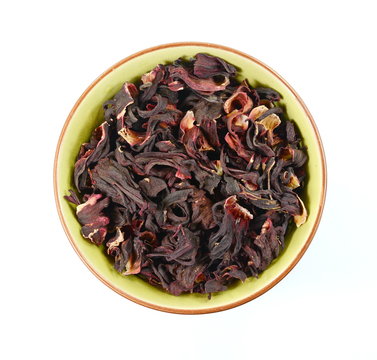 Hibiscus tea in a ceramic bowl isolated on white background.