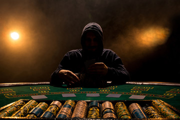 Portrait of a professional poker player sitting at poker table