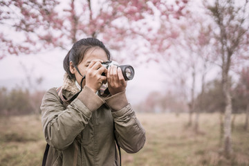 woman photographer shooting in the forest with nature beautiful background