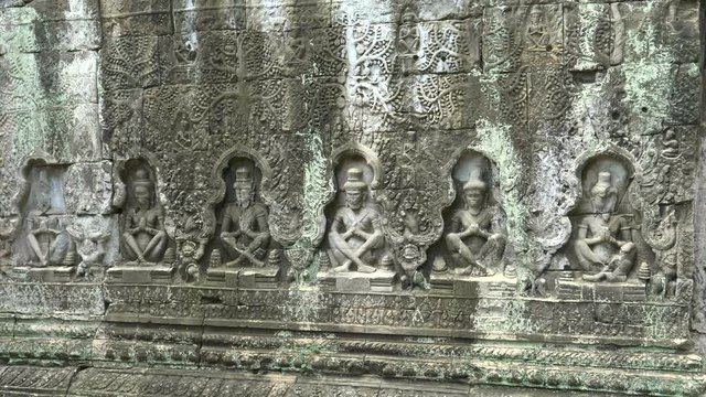carved bas relief of seated figures at preah khan temple near angkor wat, cambodia