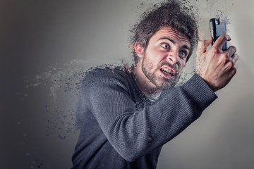 Young man insanely furious yelling at his phone, giving off steam and smoke