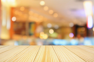 wooden table top with abstract blurred cafe restaurant bokeh lights defocused background