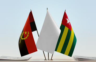 Flags of Angola and Togo with a white flag in the middle