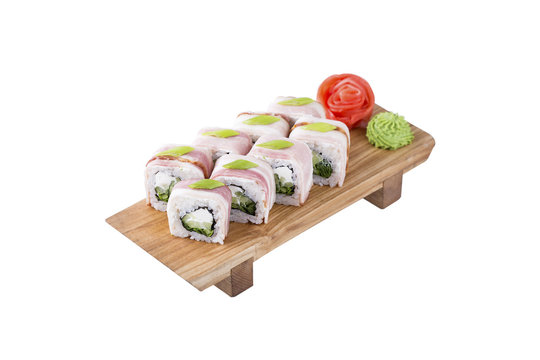 Sushi set on a wooden board, isolated.