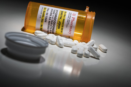 Hydrocodone Pills and Prescription Bottles with Non Proprietary Label. No model release required - contains ficticious information.