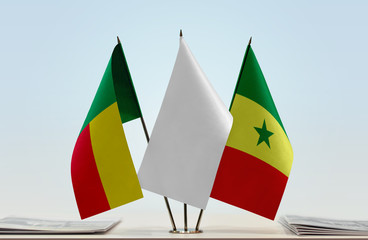 Flags of Benin and Senegal with a white flag in the middle