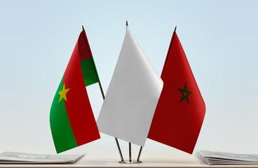 Flags of Burkina Faso and Morocco with a white flag in the middle