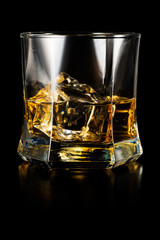 Glass of whisky isolated on black background
