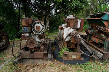 Fototapeta na wymiar Grain Image: Close up of old machine factory made of steel and used in the past. Broken and rustic machine left over in abandon factory. Image of aged equipment with rust and gear part.