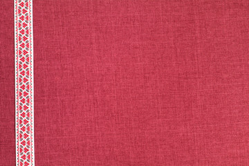 Tape with ornament on fabric background with empty space. National spirit