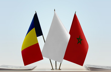 Flags of Chad and Morocco with a white flag in the middle