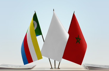 Flags of Comoros and Morocco with a white flag in the middle