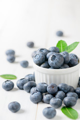 fresh blueberry fruits with leaf on white glass