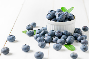 fresh blueberry fruits with leaf on white glass