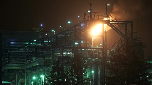 Oil, gas torch. Preparation and production of petroleum products. The oil factory. A bright sight in the night.