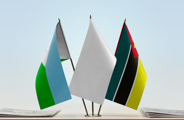 Flags of Djibouti and Mozambique with a white flag in the middle