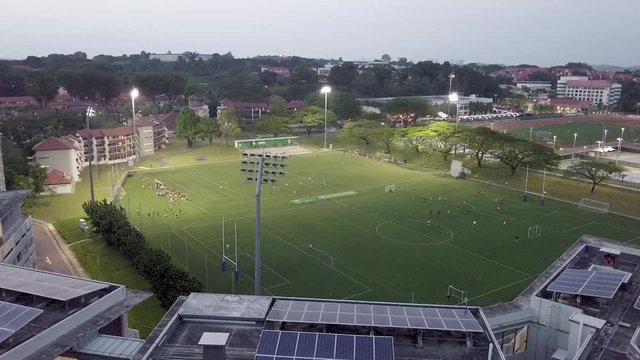 Drone Rotating Around Nanyang Technological University Sports Field In Singapore