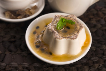 Panna cotta dessert with passion fruit and mint