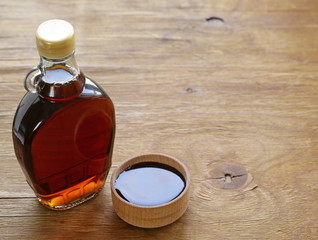 Maple syrup in a glass bottle - sweet dessert sauce