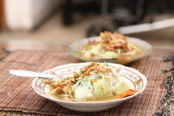 yellow spicy chicken soup with lontong