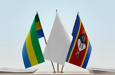 Flags of Gabon and Swaziland with a white flag in the middle