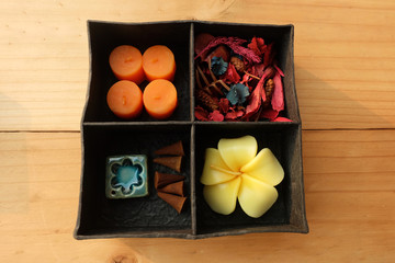 Spa Aroma therapy set in box, Candle Aroma, Roses Shaped Candles, incense sticks and dry flower on wooden floor