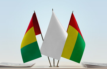Flags of Guinea and Guinea-Bissau with a white flag in the middle