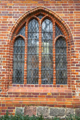 window of a brick Gothic building in Berlin, Germany