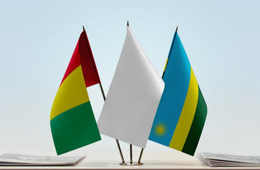 Flags of Guinea and Rwanda with a white flag in the middle
