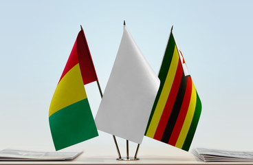 Flags of Guinea and Zimbabwe with a white flag in the middle