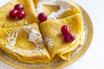 multicolored pancakes with berries