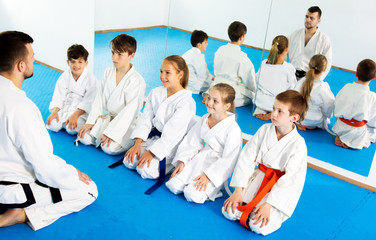 Fototapeta na wymiar Children enjoying their trainings with coach at karate