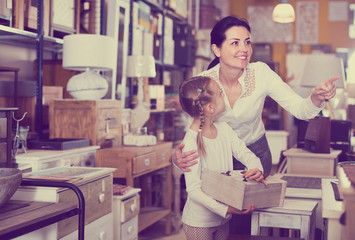 Woman with girl in furniture store