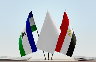 Flags of Lesotho and Egypt with a white flag in the middle