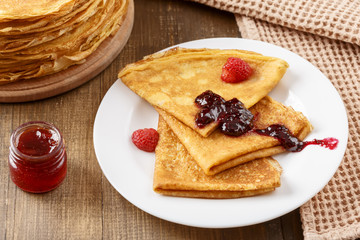 Thin pancakes on a table and on a plate