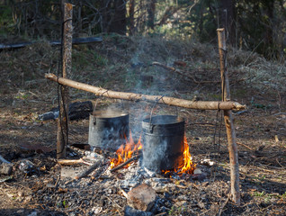 The kettles boil over the fire