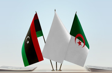 Flags of Libya and Algeria with a white flag in the middle