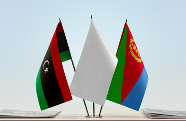 Flags of Libya and Eritrea with a white flag in the middle