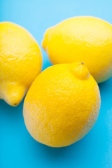 Large exotic lemons on a blue table.