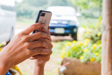 woman hands holding and using smart phone