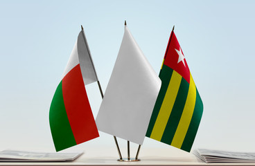 Flags of Madagascar and Togo with a white flag in the middle