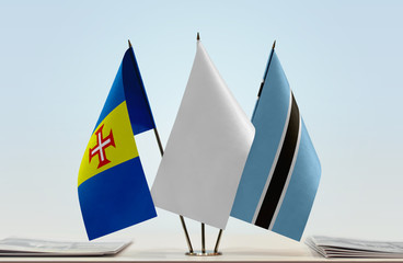 Flags of Madeira and Botswana with a white flag in the middle