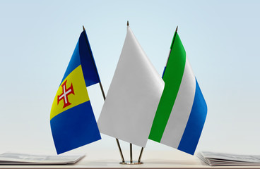 Flags of Madeira and Sierra Leone with a white flag in the middle