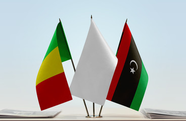 Flags of Mali and Libya with a white flag in the middle