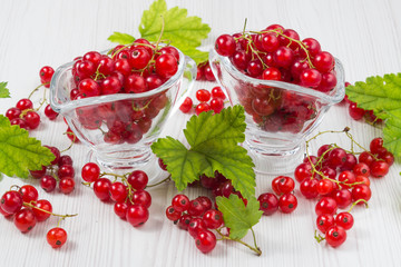 Red currant fruits on a wooden background