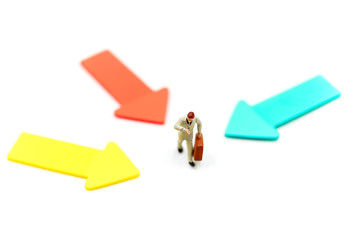 Miniature people: Businessman standing in front of arrow pathway choice using as Business decision concept