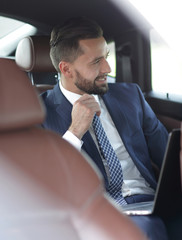 Close-up of a successful businessman sitting in a comfortable car